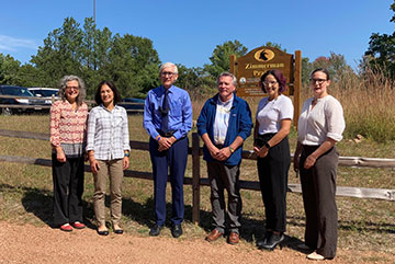Governor Evers, Susan, and other commission members meet at Zimmerman Park.