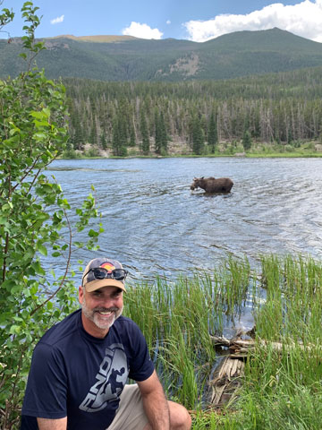 Image of Jim Cleveland watching a moose at Rocky Mountain National Park.