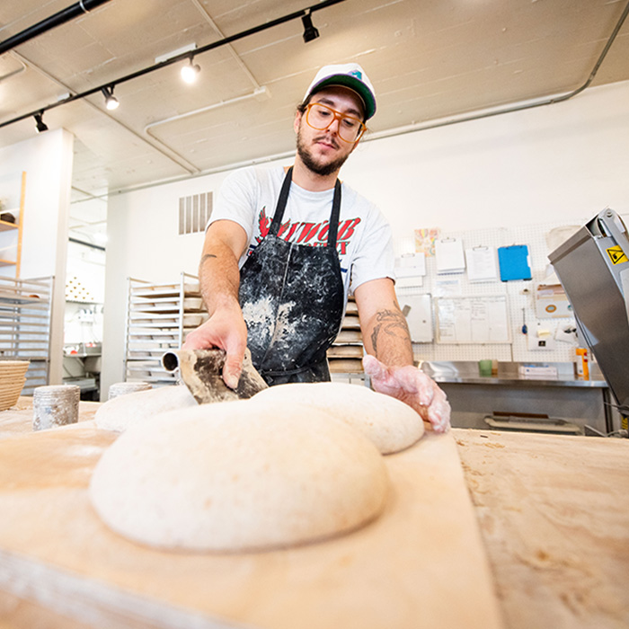 A man making bread dough in a bakery.