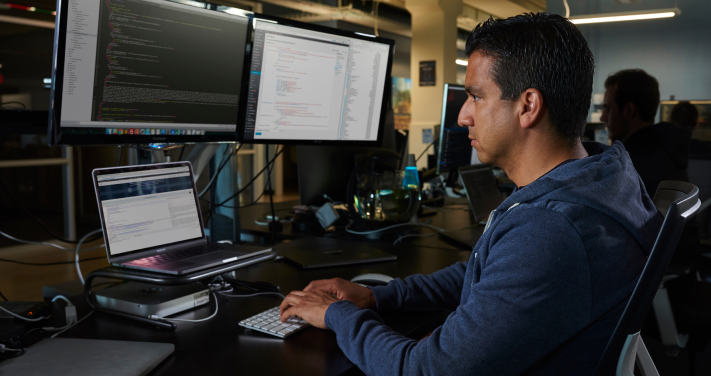 A man working on the computer at an office.