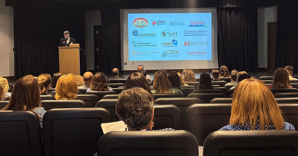 CEC conference attendees sitting in an auditorium listening to a presentation.