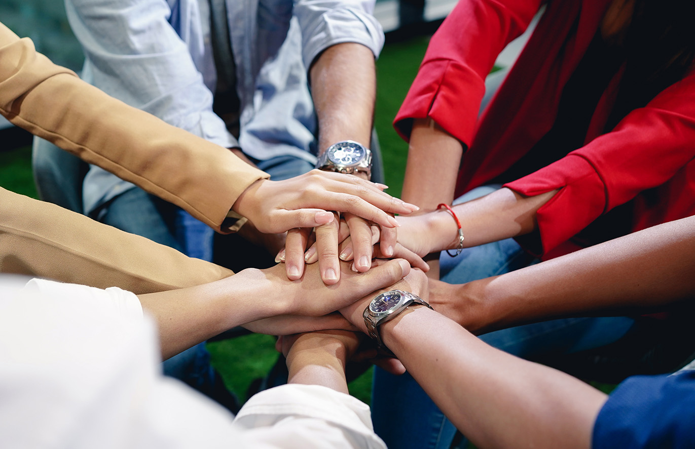 A group of people all putting their hands in.